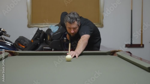 Close-up of a Man Playing Billiards and Pocketing a Ball