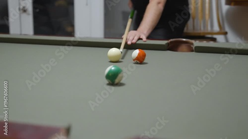 Close-up of a Man Playing Billiards and Pocketing a Ball