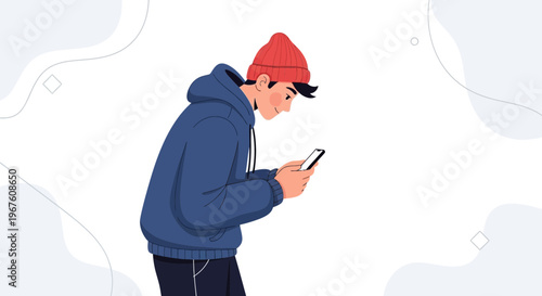 Young man in red beanie and blue hoodie engrossed in smartphone