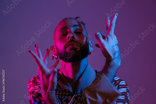 Retro wave or synth wave portrait stylish serious african-american dancer man studio shoot. High Fashion male model dance in colorful bright neon lights posing.