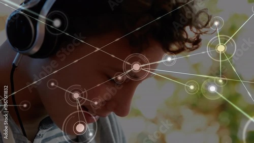 Animation of network of connections over caucasian student using headphones