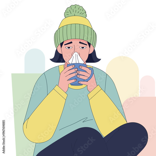 Sick woman with a cold drinking hot tea.
