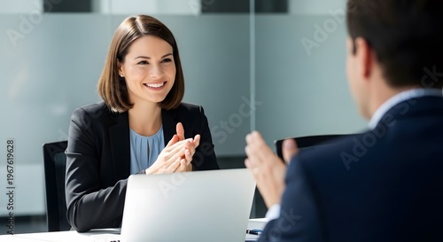 Smiling businesswoman in a meeting with a colleague office