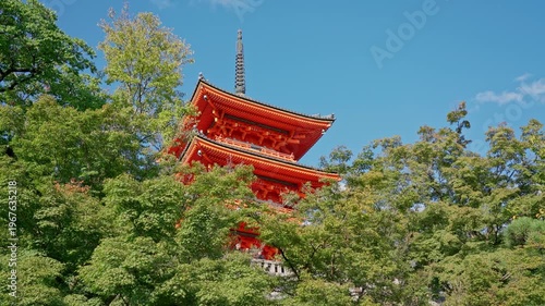 Kyoto, Japan - Oct 11 2024, 4k, panoramic view from below of the Kiyomizu-dera Temple pagoda peeking out from behind the treetops, without people, at daytime, Kyoto, Japan