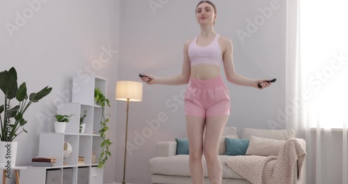 Woman training with skipping rope at home