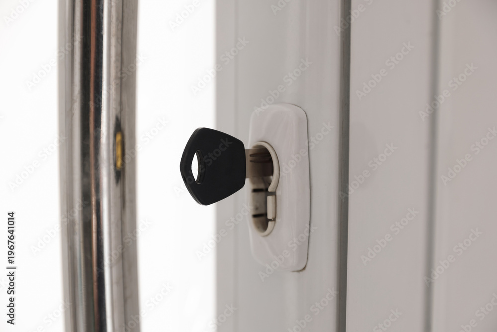Naklejka premium Door with keys and metal handle indoors, closeup