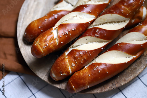 Long pretzels laugenstange on a wooden tray