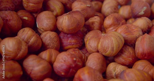 Peeled hazelnut kernels lie on a plate. Close-up