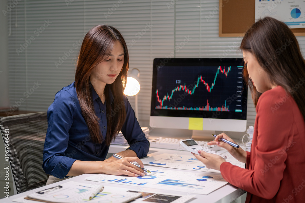 Fototapeta premium Businesswomen analyzing financial data and market trends
