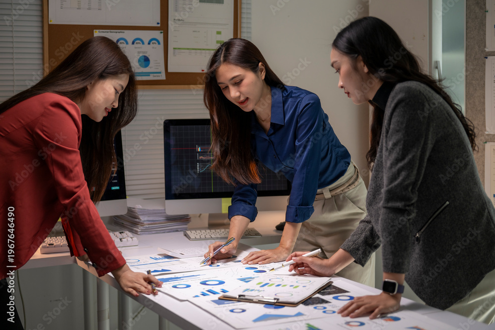 Fototapeta premium Business women collaborating on financial data analysis in office