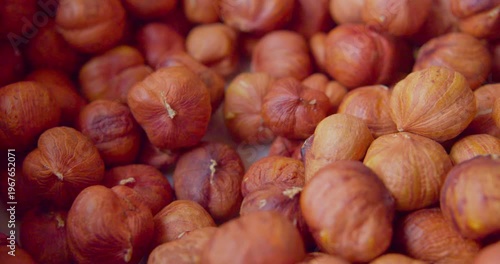 Peeled hazelnut kernels lie on a plate. Close-up