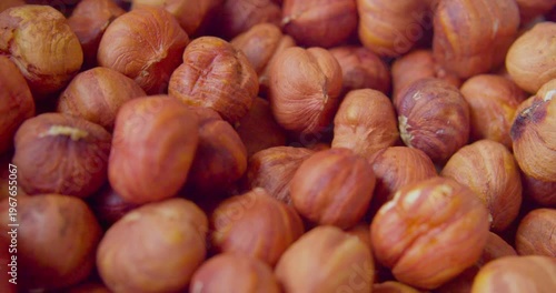 Peeled hazelnut kernels lie on a plate. Close-up