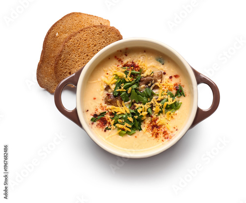 Bowl of tasty cheese soup with parsley and croutons on white background