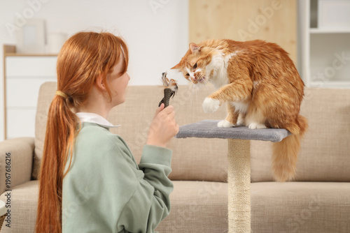 Redhead teenage girl playin...