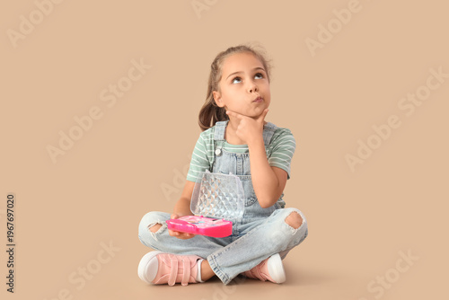 Thoughtful little girl with...