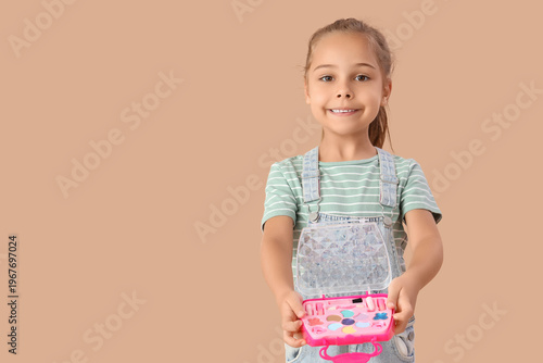 Cute little girl with cosme...
