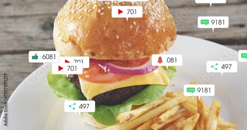 Displaying burger with sesame bun and melting cheddar over beef patty on wooden table badges shown