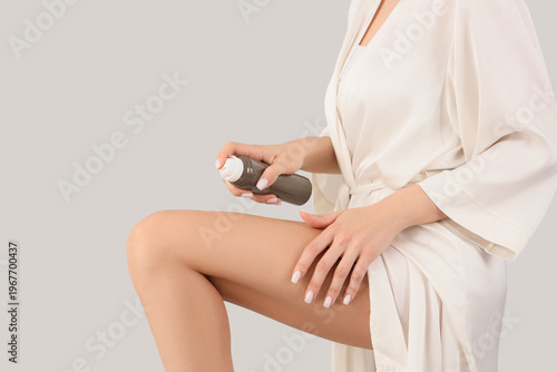 Young woman in bathrobe app...
