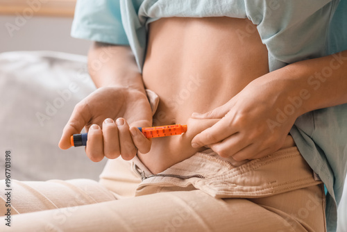Woman injecting herself wit...