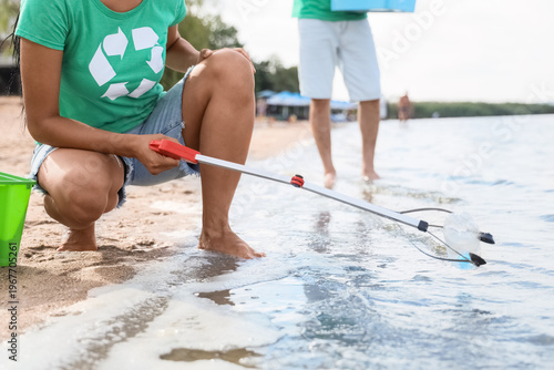 Female volunteer cleaning u...