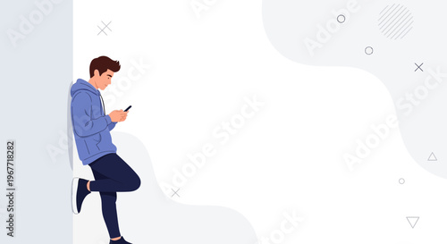 Young man in hoodie using smartphone, leaning on wall, modern abstract background