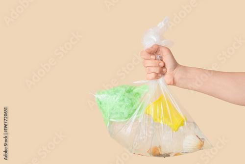 Hand holding bag with seash...