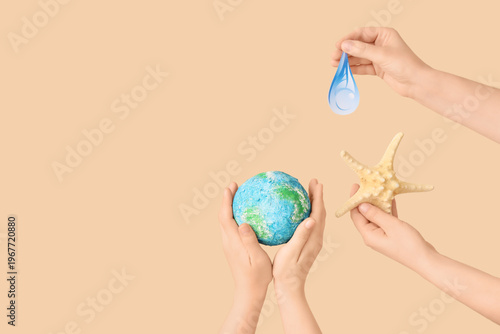 Hands holding model of Eart...