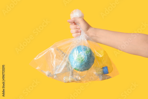 Hand holding plastic bag wi...