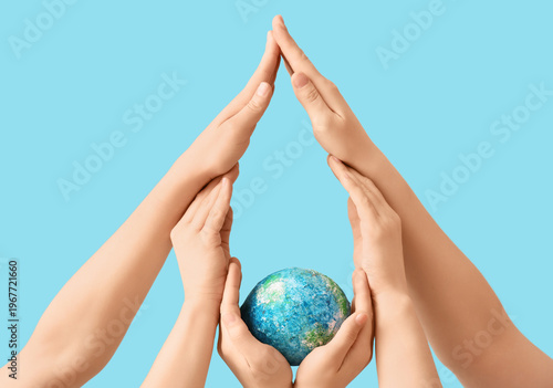 Hands with model of Earth f...