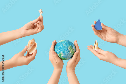 Hands holding model of Eart...