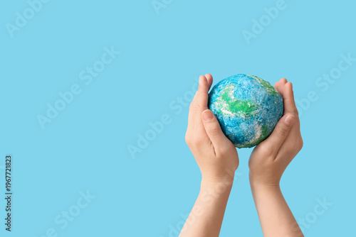 Hands holding model of Eart...