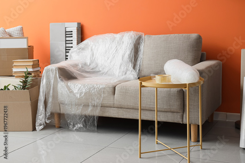 Grey sofa with stretch film...