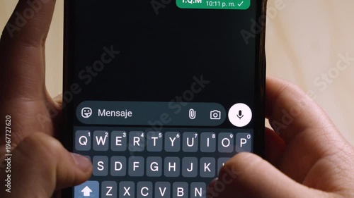 Close-up of hands typing the Spanish acronym 