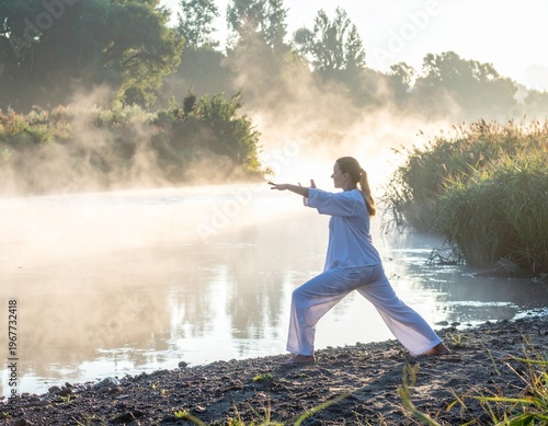 Wallpaper Mural Woman Practicing Tai Chi by Misty River at Sunrise. Torontodigital.ca