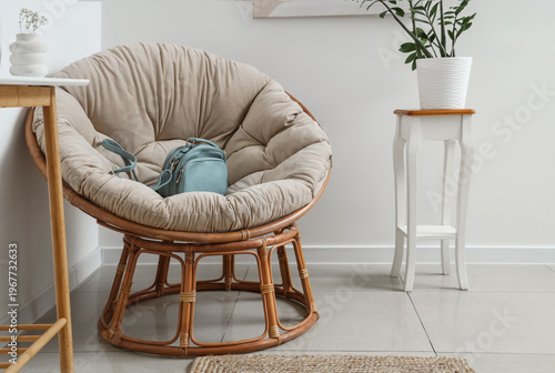 Stylish bag on armchair in ...