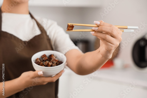 Young Asian woman with tast...