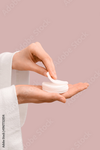 Female hand with cotton pad...