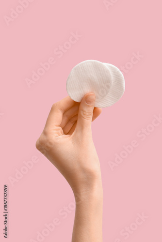 Female hand with cotton pad...