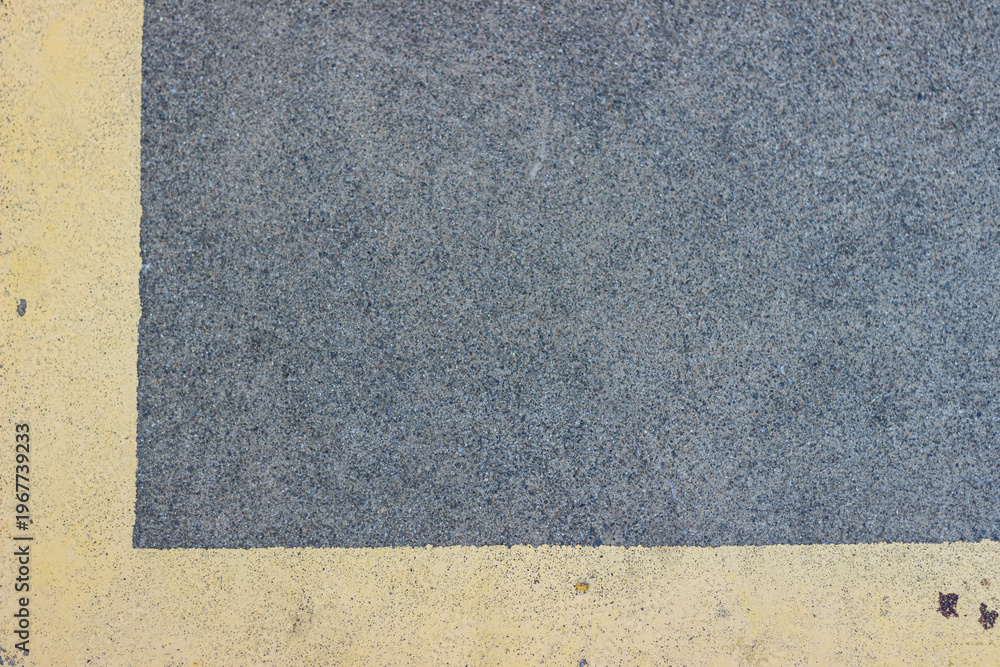 Fototapeta premium Asphalt surface with yellow marking line and textured background creates road backdrop with contrast lines and rough surface