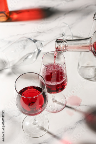 Pouring of red wine into gl...