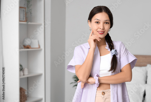Young Asian woman with brai...