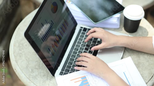 Ambitious businesswoman working on laptop in modern office, collaborating with diverse team, brainstorming ideas, planning strategy, and driving innovation and career success.
