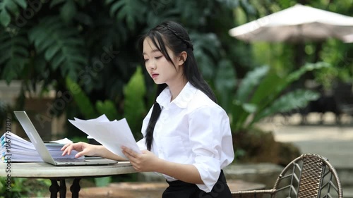 Ambitious businesswoman working on laptop in modern office, collaborating with diverse team, brainstorming ideas, planning strategy, and driving innovation and career success.

