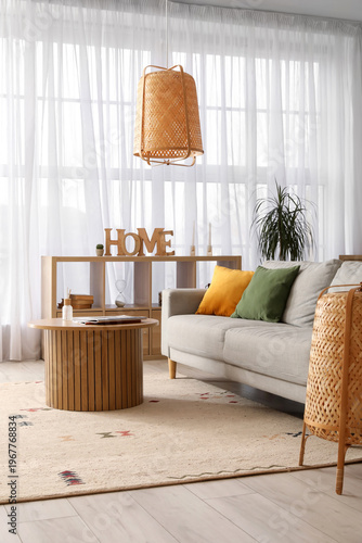 Quadro su tela Interior of cozy living room with grey sofa, wooden table and shelf unit