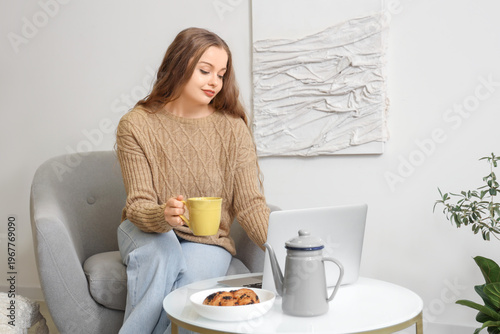 Young woman with cup of tea...