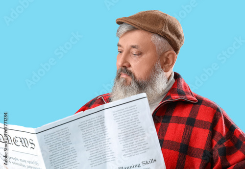 Mature man reading newspape...
