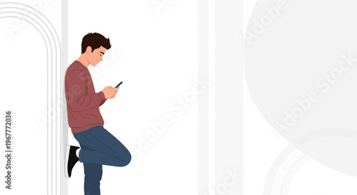 Young man leaning against wall, looking at smartphone, modern minimalist background