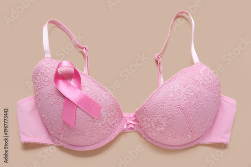Bra with pink ribbon on bei...