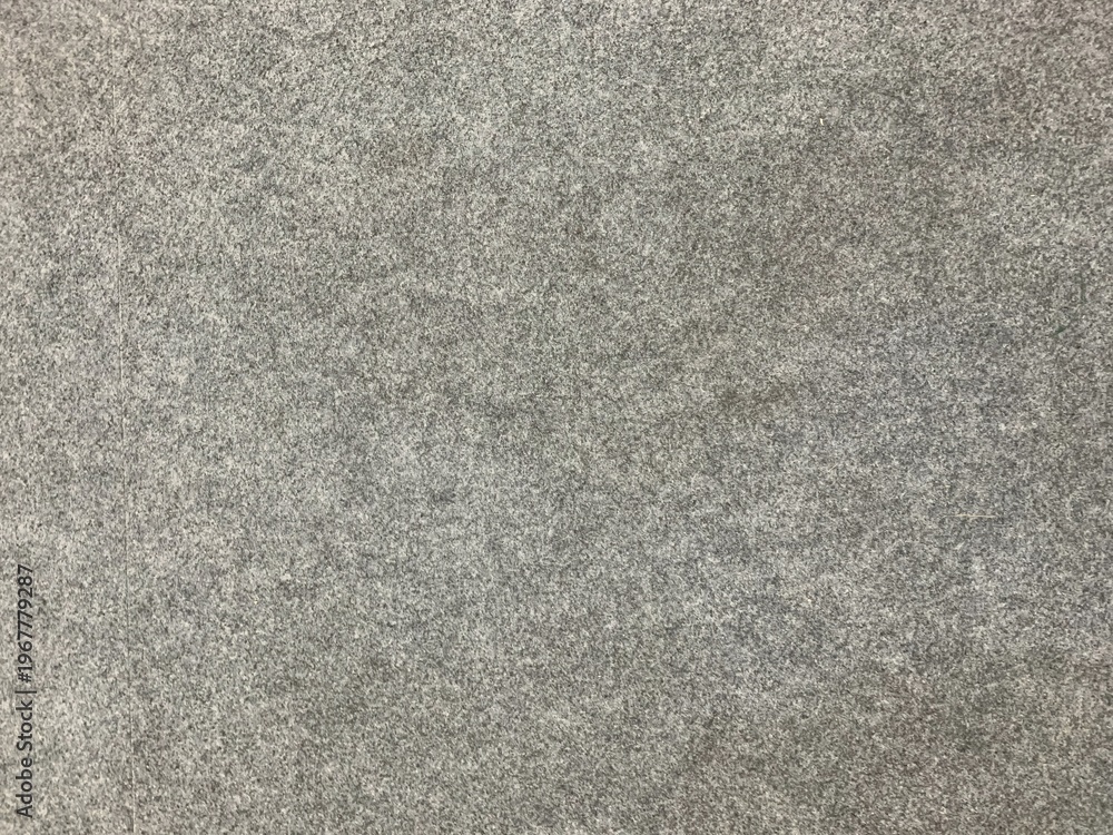 Fototapeta premium Minimalist grey felt texture with soft fiber detail. Uniform industrial fabric surface ideal for interior design, upholstery, and textile backgrounds.