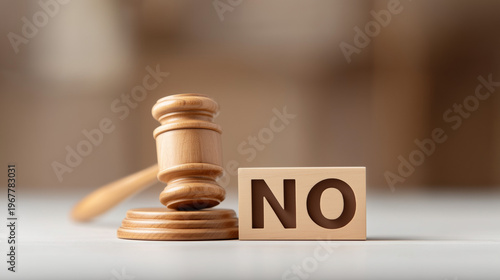 Legal Verdict: A wooden gavel rests beside a block displaying the word 'NO', symbolizing a decisive judgment and the denial of a request. the scene embodies a clear, definitive message.
